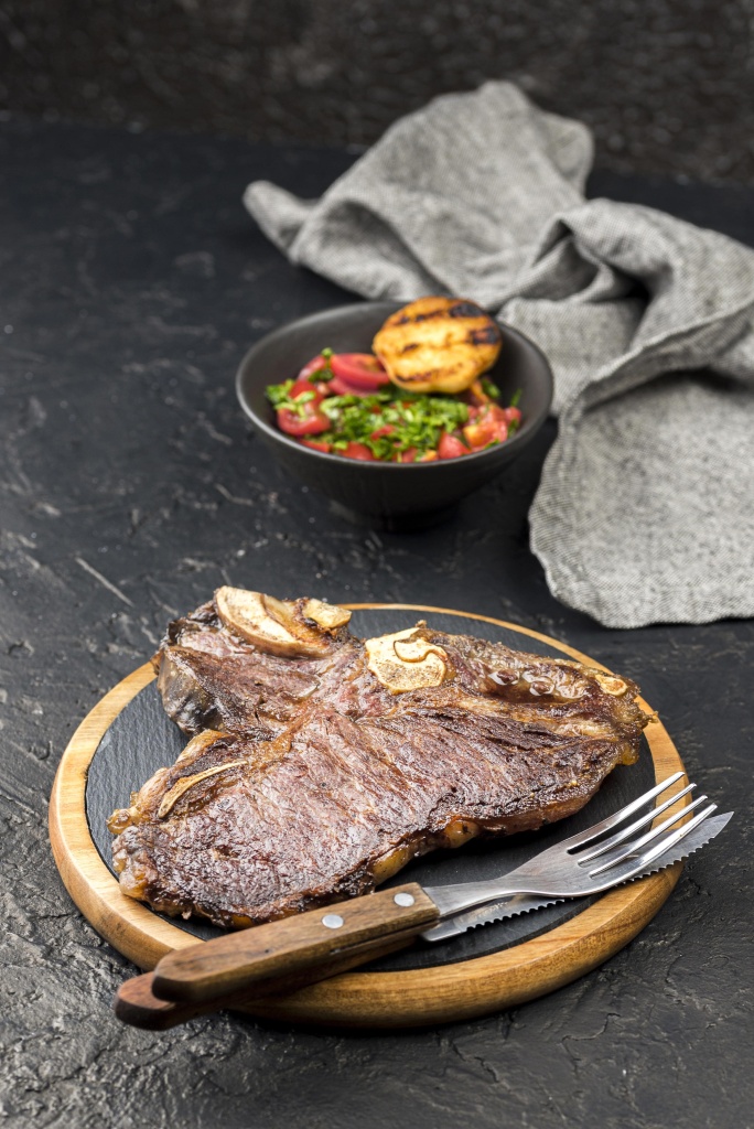 high-angle-steak-with-salad-cutlery-min.jpg